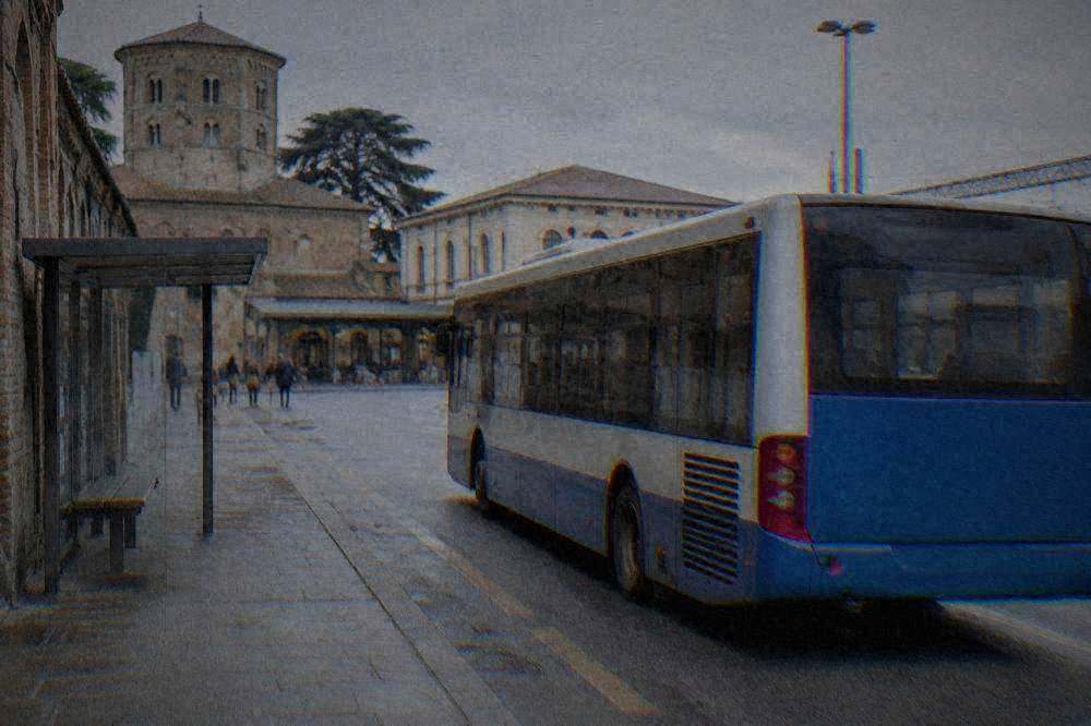 A regional train waiting at Ravenna railway station under a clear sky