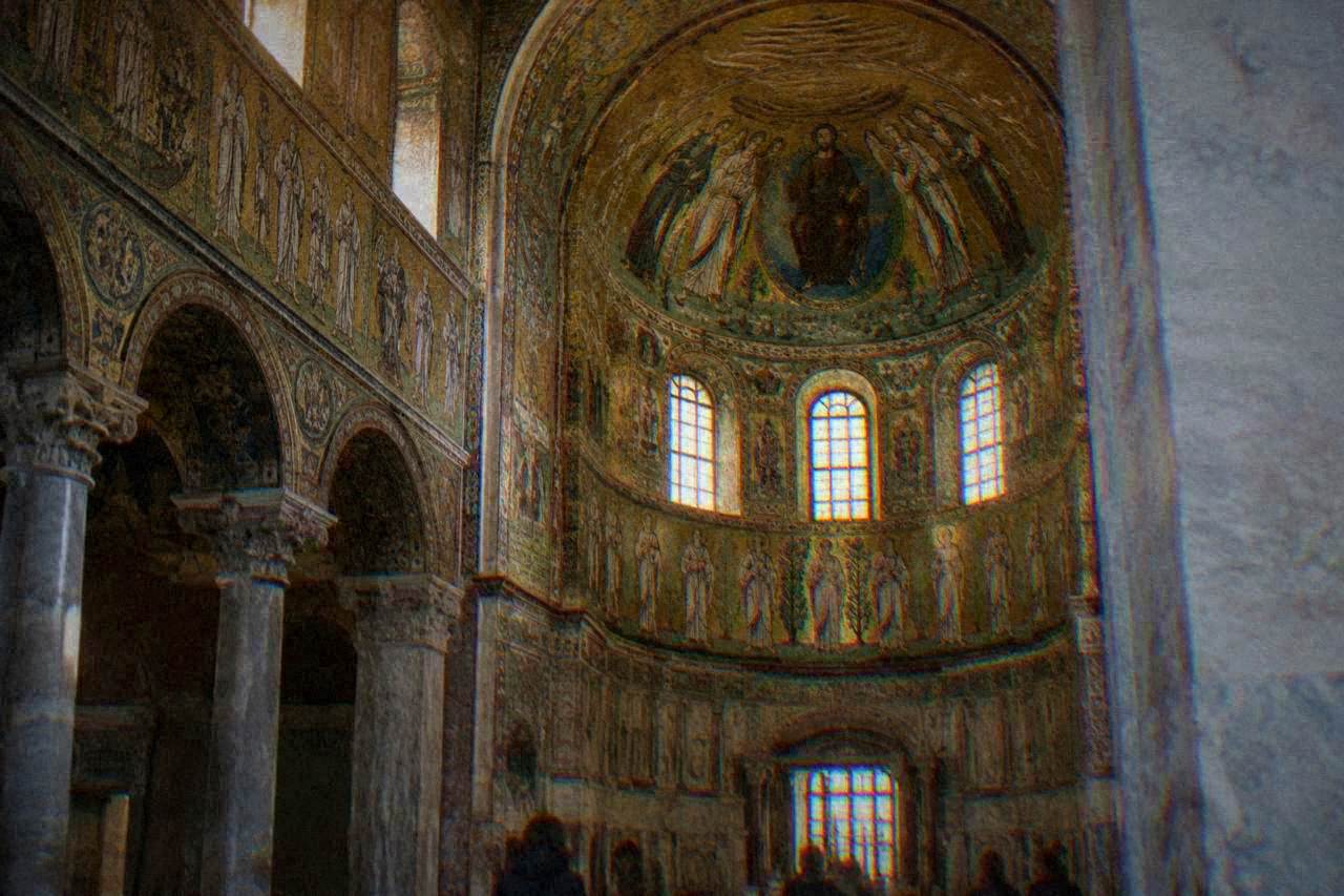 A gilded Byzantine mosaic interior in Ravenna lit softly under a domed ceiling