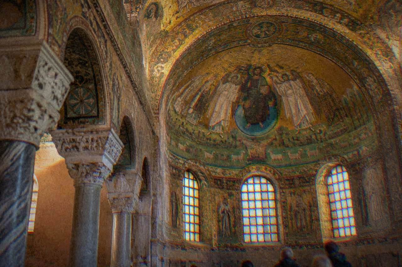 Golden Byzantine mosaics covering the dome and walls of an ancient Ravenna church interior