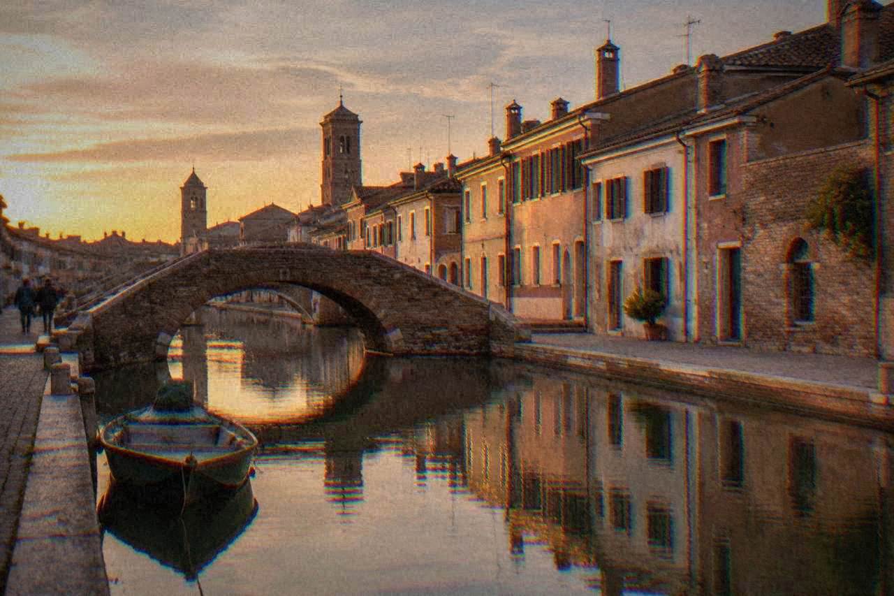 Canals and low bridges of a small lagoon town at golden hour