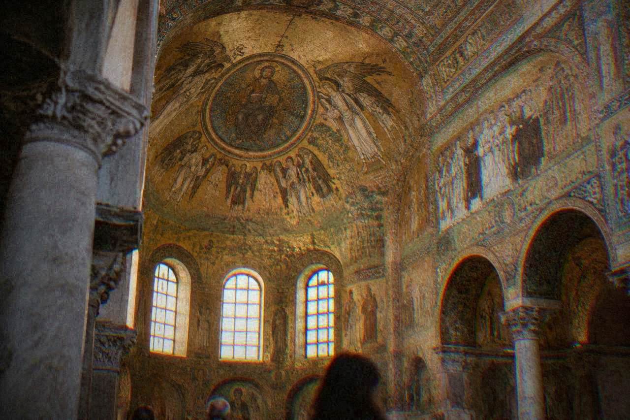 Golden Byzantine mosaics covering the vaulted interior ceiling of an ancient Ravenna church