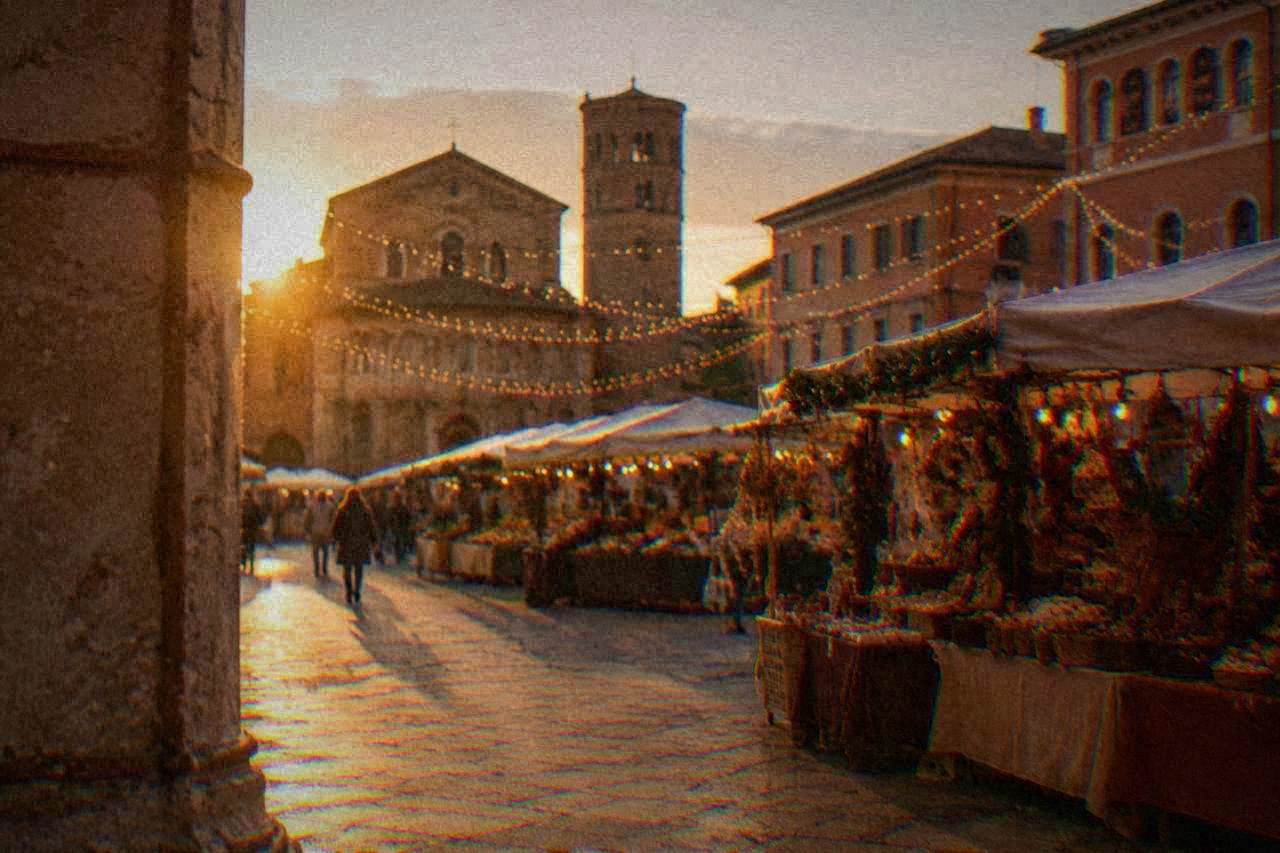 Festive wooden market stalls arranged in a lit Italian square in the evening