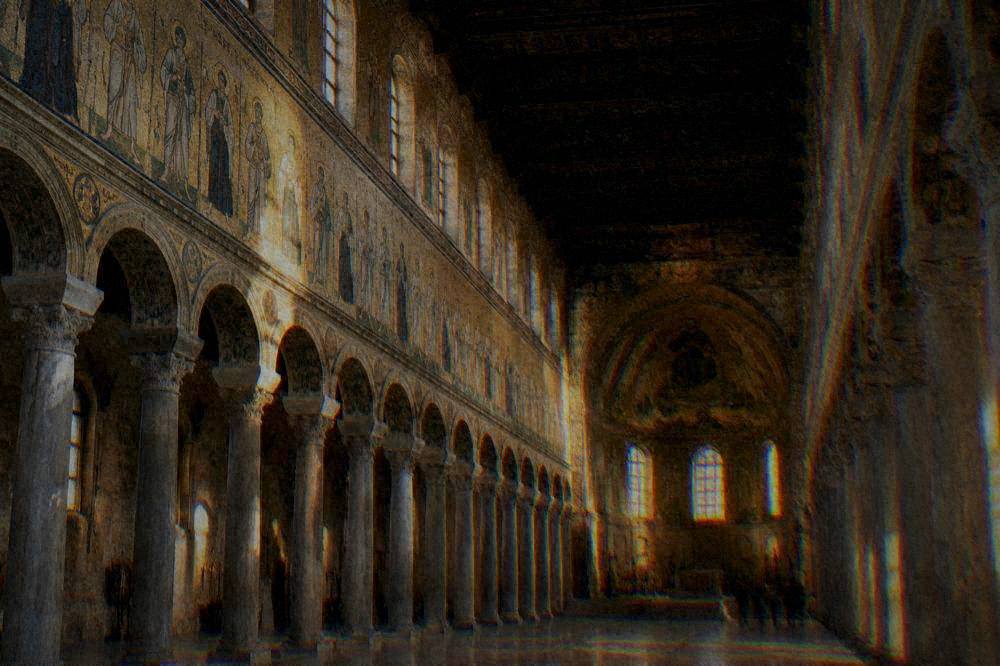 A long basilica nave lined with processional mosaic figures on a gold background