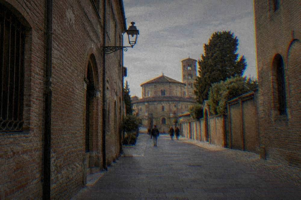 A quiet pedestrian street of old brick buildings in central Ravenna