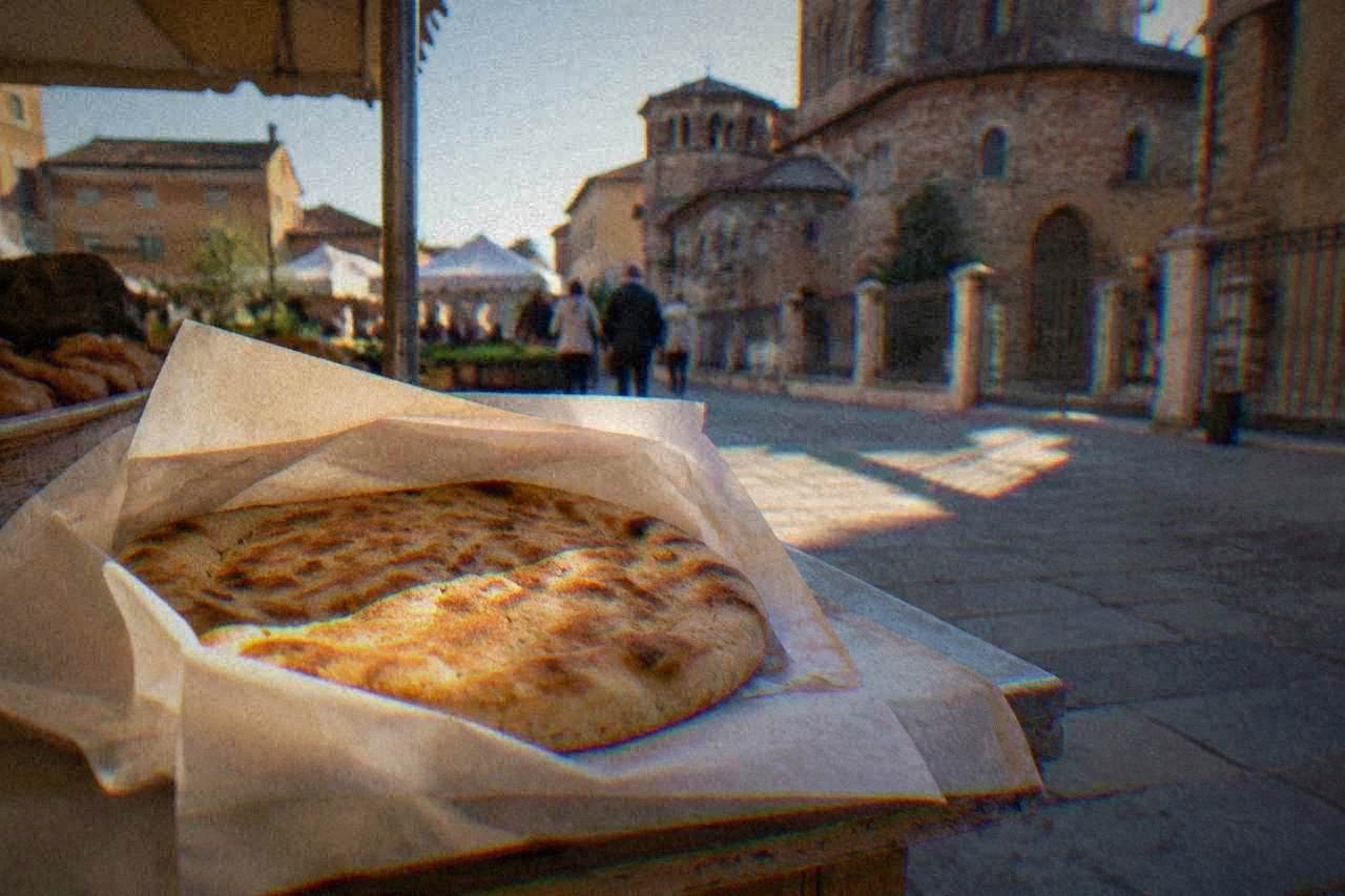A round flatbread wrapped in paper on a market stall counter
