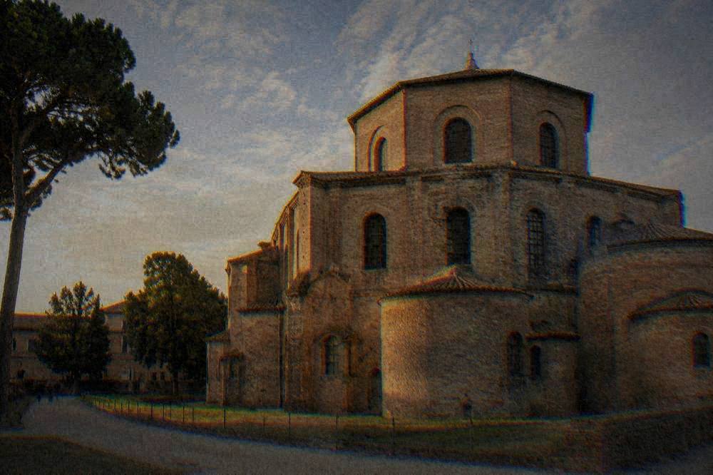 The plain brick exterior of an ancient Ravenna monument under a wide sky