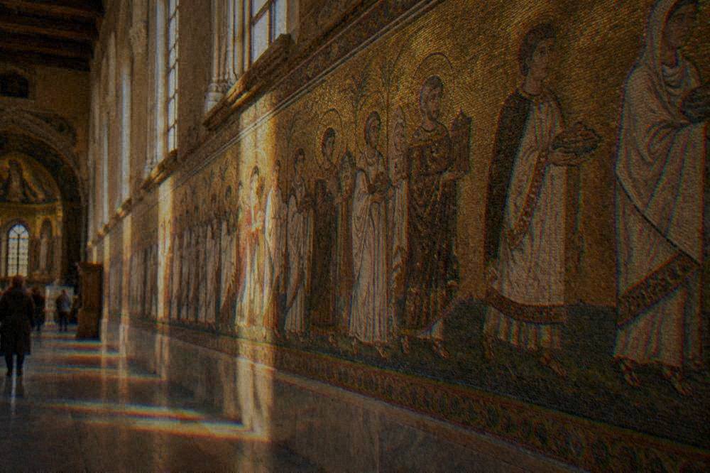 Rows of ancient stone sarcophagi standing along the side aisle of the basilica