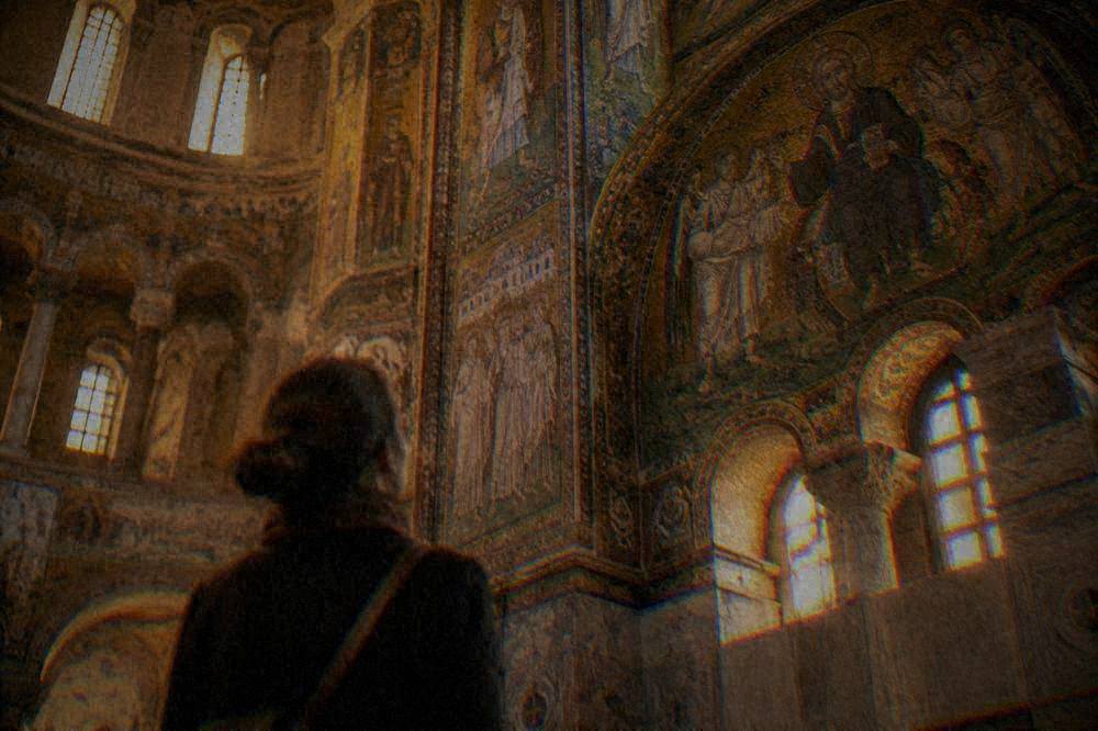 Interior arcade of a Ravenna basilica lined with early Christian wall mosaics