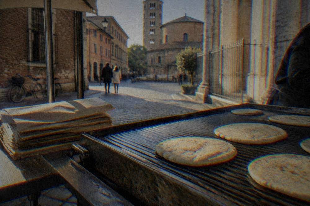 Flat dough rounds cooking on a ridged hot plate beside a stack of folded paper wrappers