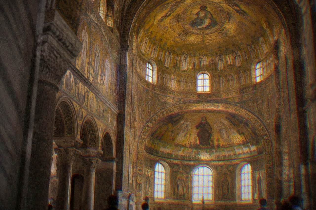 Golden Byzantine mosaics covering the dome and walls of an ancient Ravenna church interior