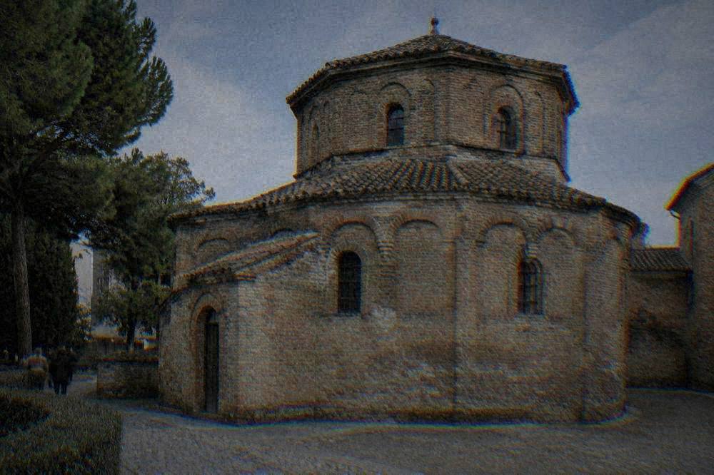 Brick exterior of an ancient mausoleum in Ravenna under a blue sky