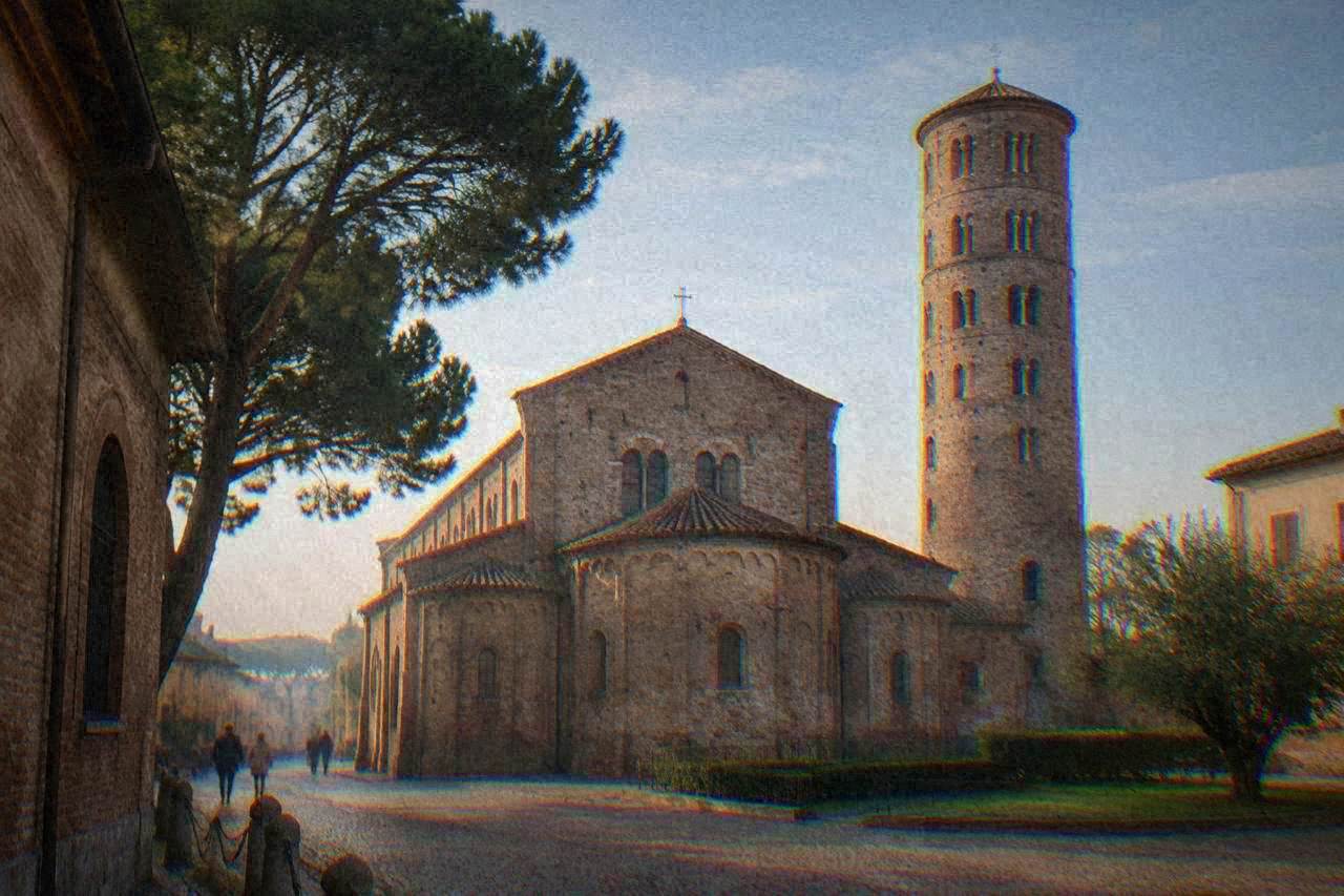 The brick dome and bell tower of the Basilica of San Vitale in Ravenna under a clear sky