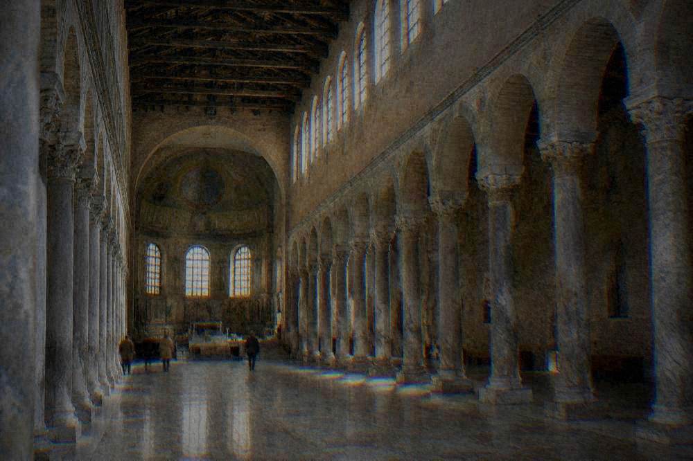 A long basilica nave lined with marble columns and lit by high clerestory windows