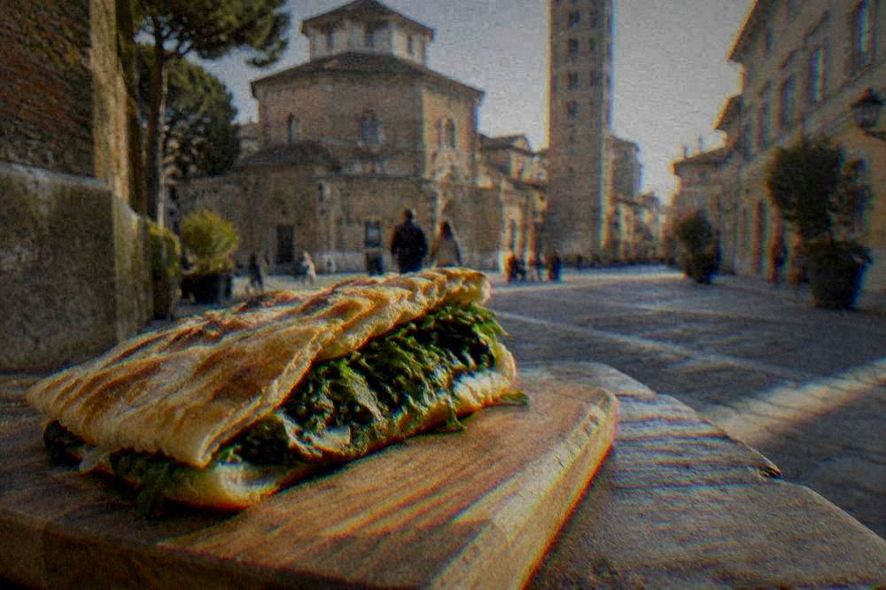 A rustic Italian flatbread folded and filled with greens on a wooden board