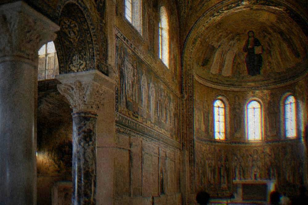Golden mosaic interior of an early Christian church lit through narrow windows