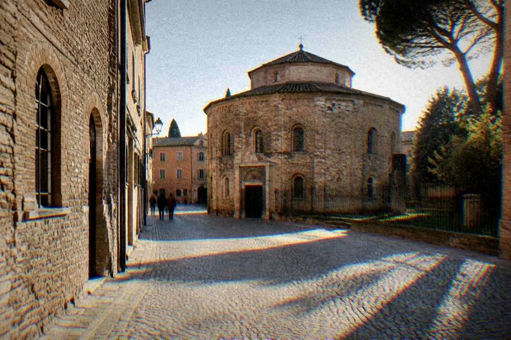 Cobbled street and old brick buildings in the historic centre of Ravenna on a sunny day