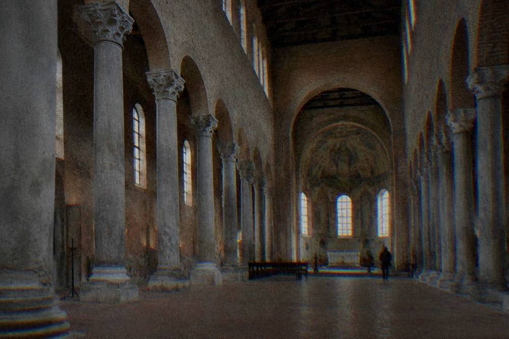 Simple brick interior of the Basilica of San Francesco with columns and side aisles