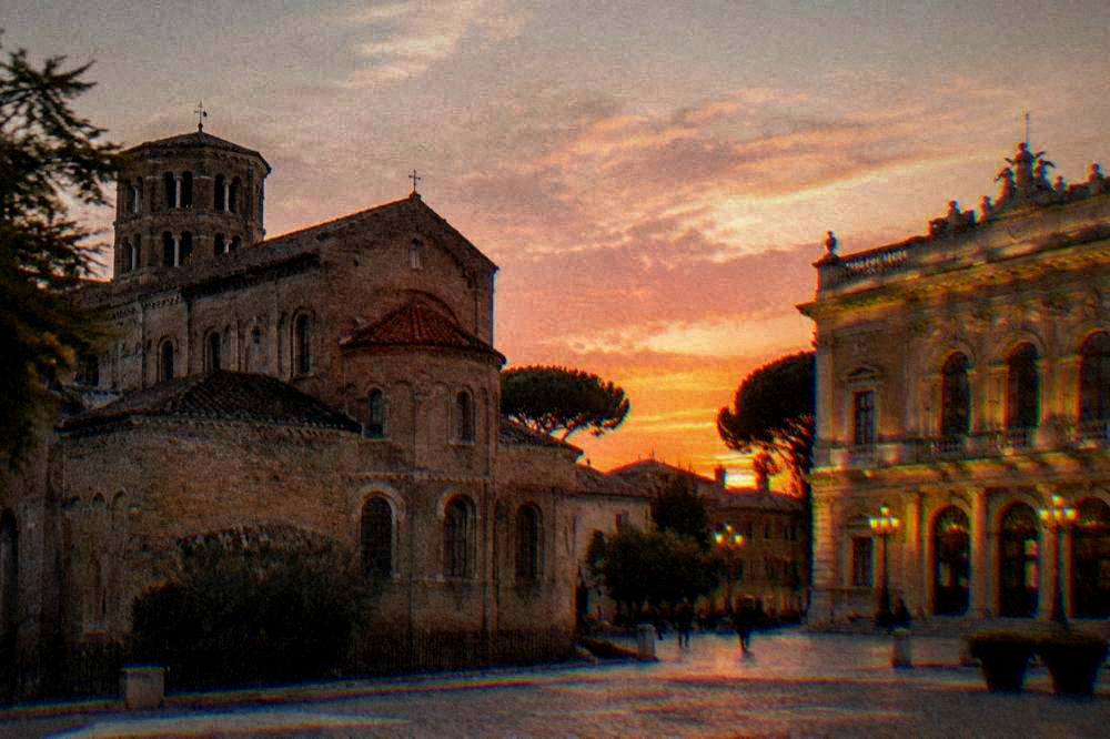 Teatro Alighieri theatre facade lit at dusk in Ravenna
