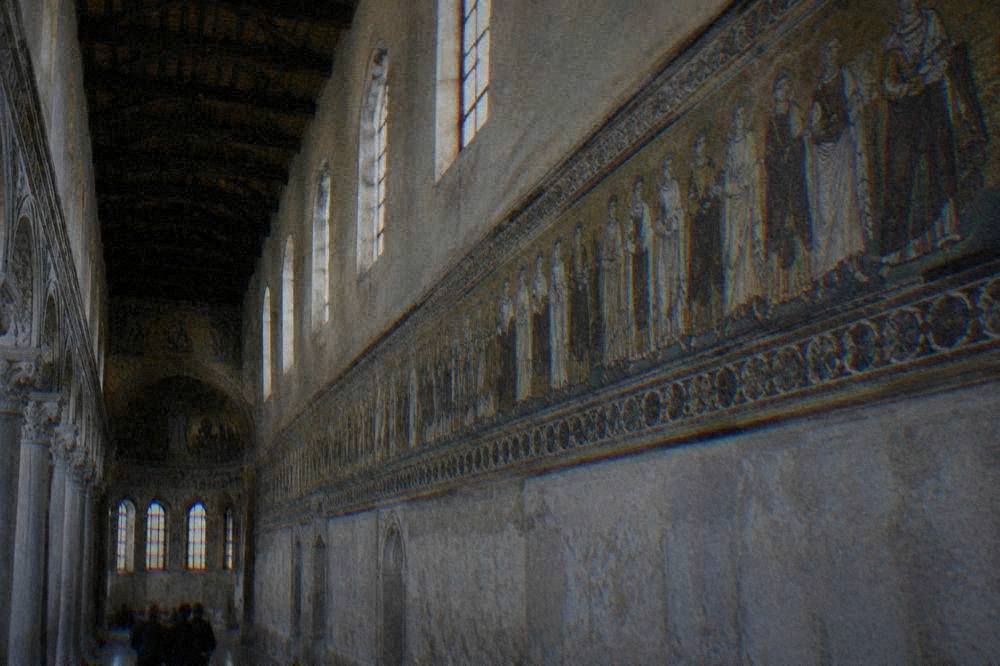 Side wall of a basilica with a narrow mosaic frieze of figures extending along the upper wall