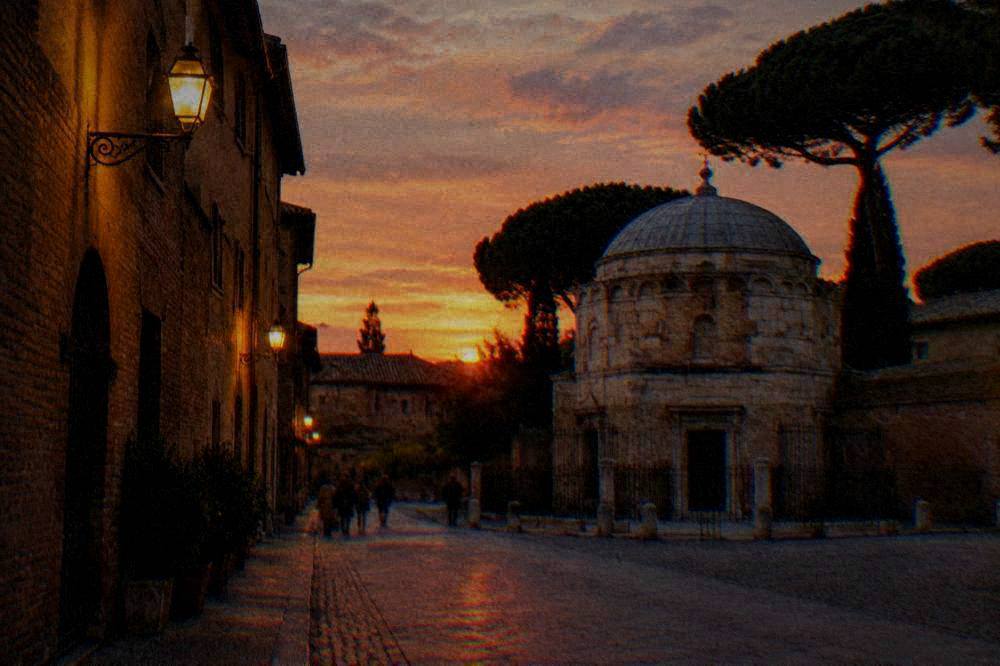 An evening street in Ravenna with warm lamp light on old brick facades