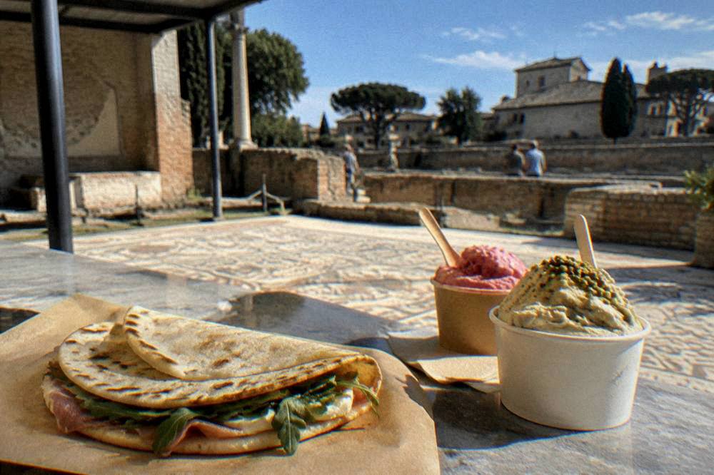 Handmade piadina flatbread and gelato cups on a café counter in an Italian town