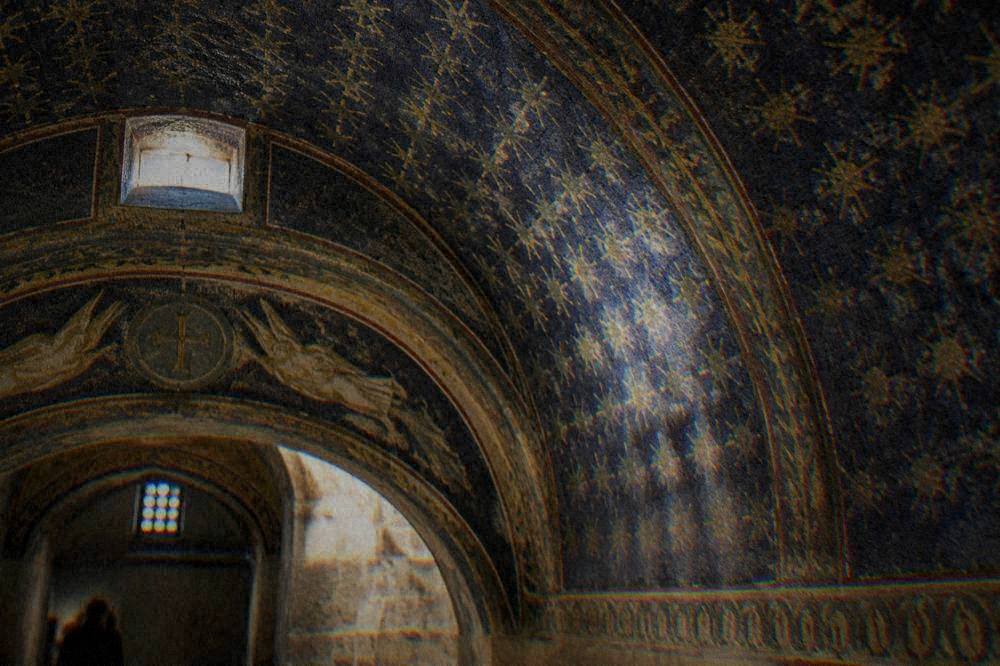 A close view of the star-patterned blue and gold mosaic vault inside the mausoleum