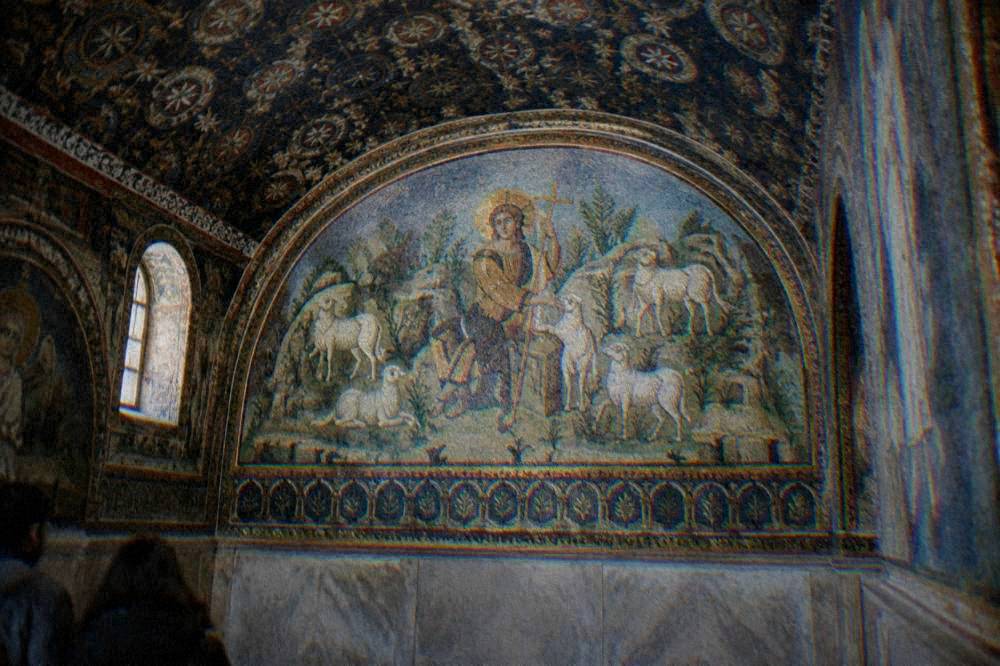 The Good Shepherd mosaic with sheep in a green landscape inside the Mausoleum of Galla Placidia