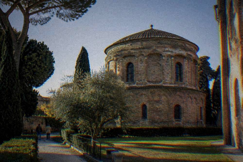 The exterior brick dome of the mausoleum seen from the garden beside the Basilica of San Vitale