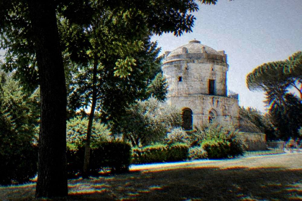 The dome of the Mausoleum of Theodoric rising above parkland trees on the edge of Ravenna