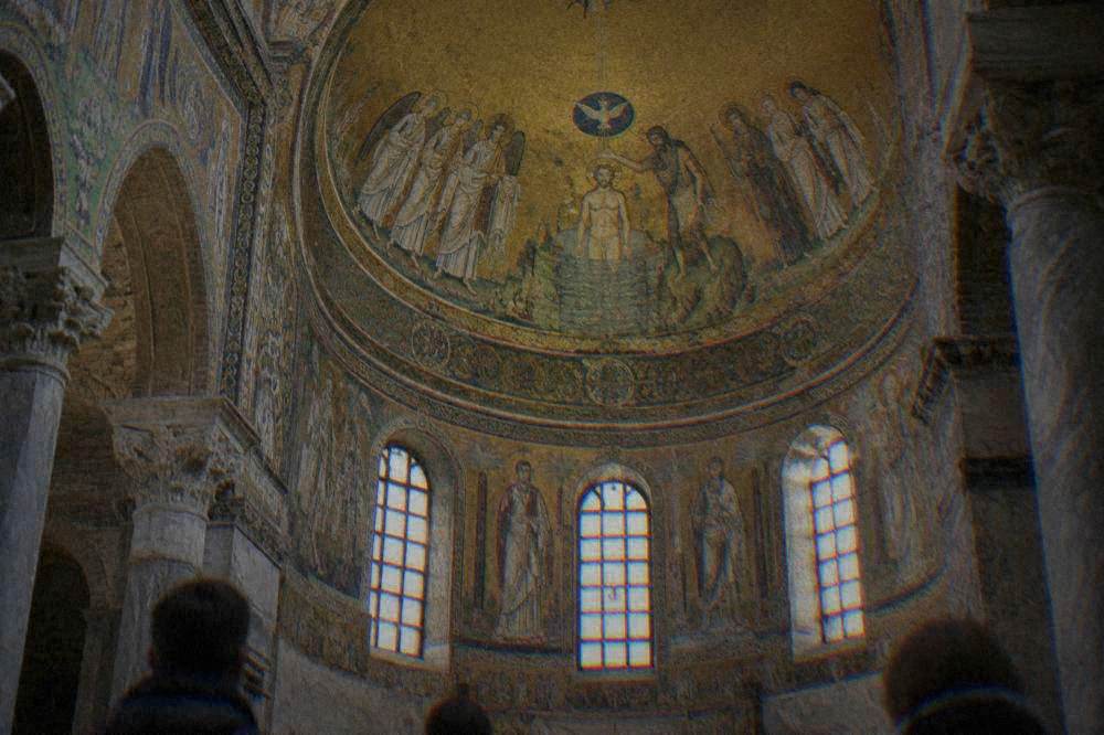 A golden mosaic dome depicting figures around a central baptism scene