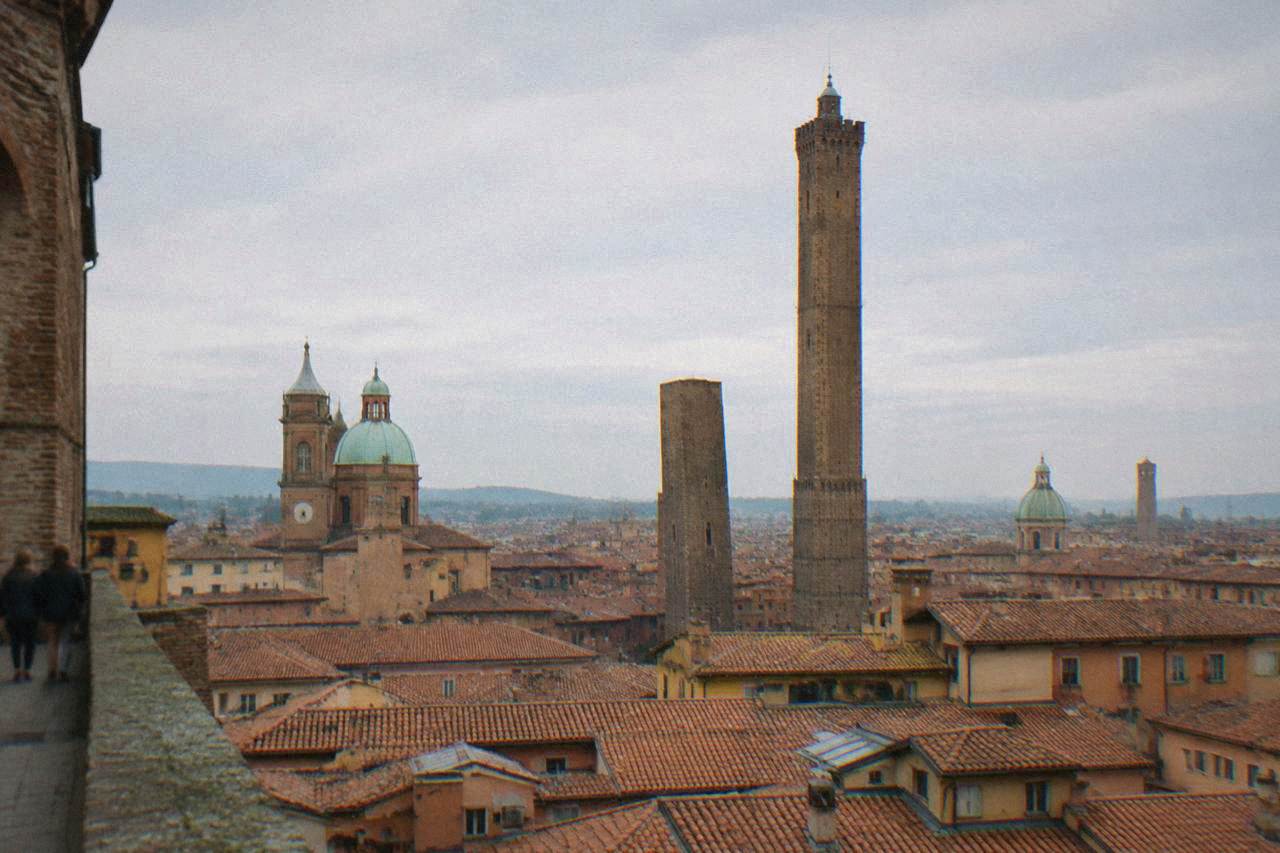 Bologna cityscape with medieval towers rising above red rooftops