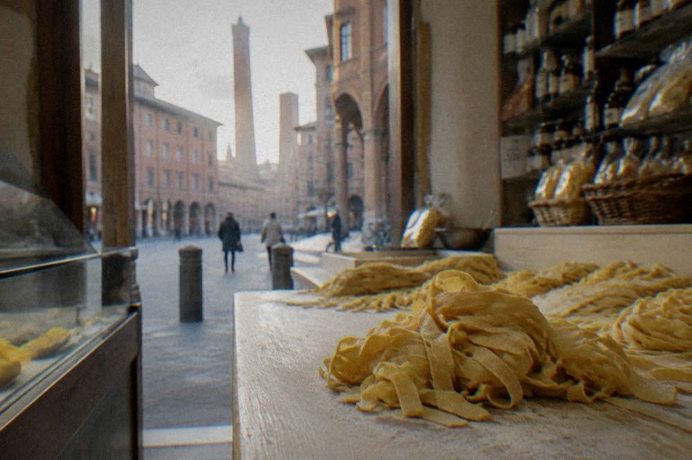 Fresh tagliatelle pasta on a counter in a Bologna food shop