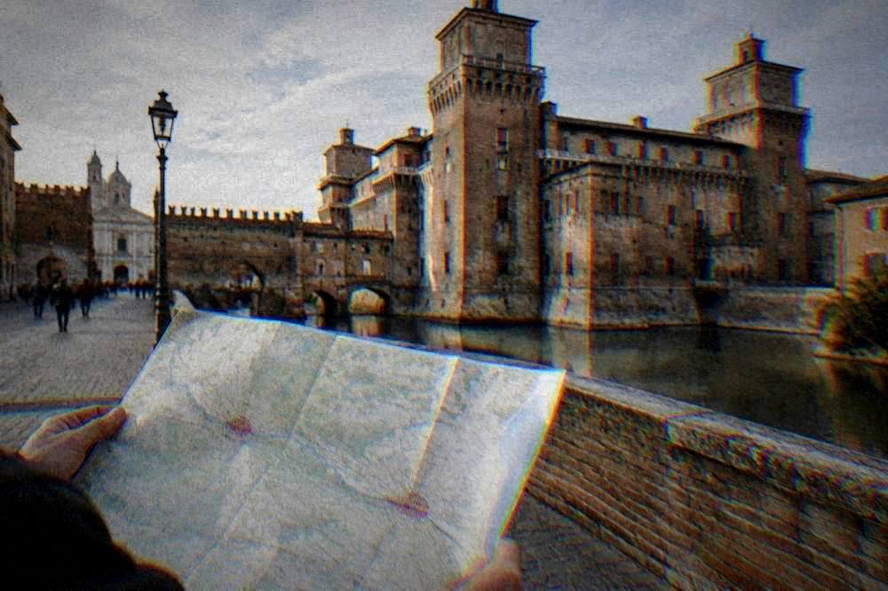 Two historic Italian cities suggested on a map of a flat green plain between a river and the coast