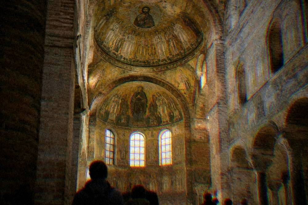 A golden Byzantine mosaic interior glowing inside an ancient brick church dome