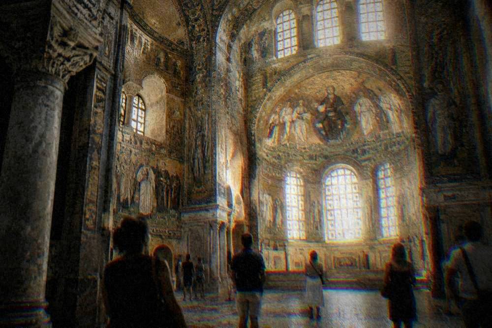 Visitors admiring glowing gold mosaics inside the basilica of San Vitale in Ravenna