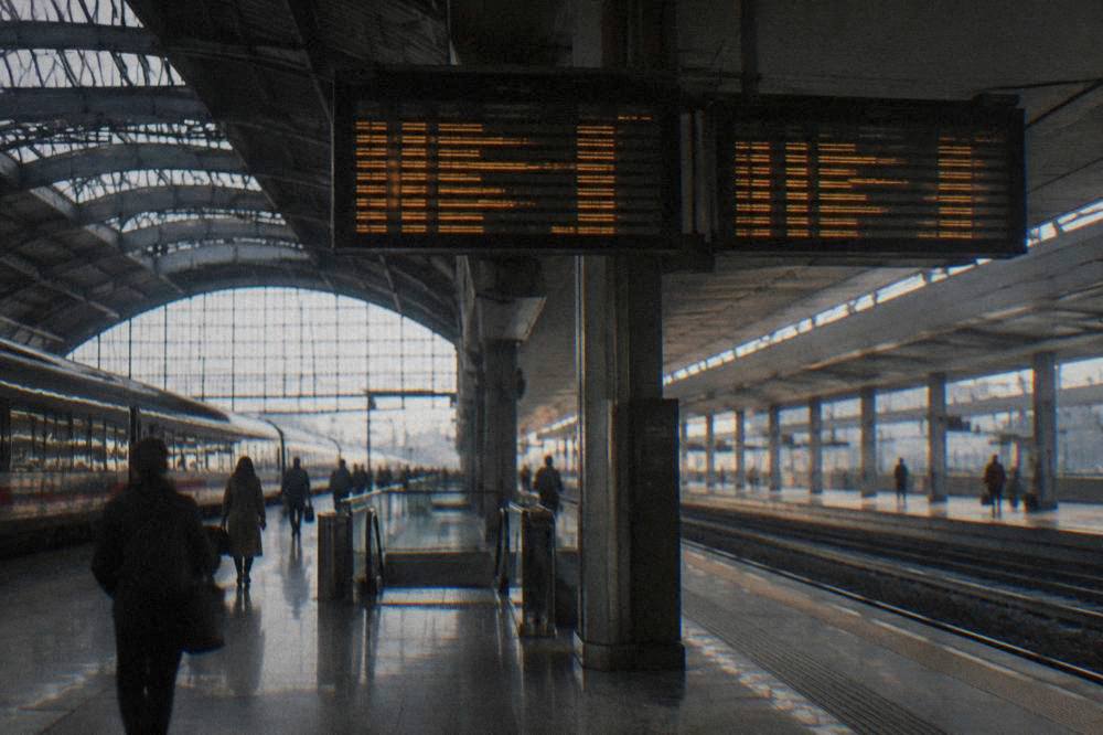 The interior of Bologna Centrale railway station with departures boards above the platforms
