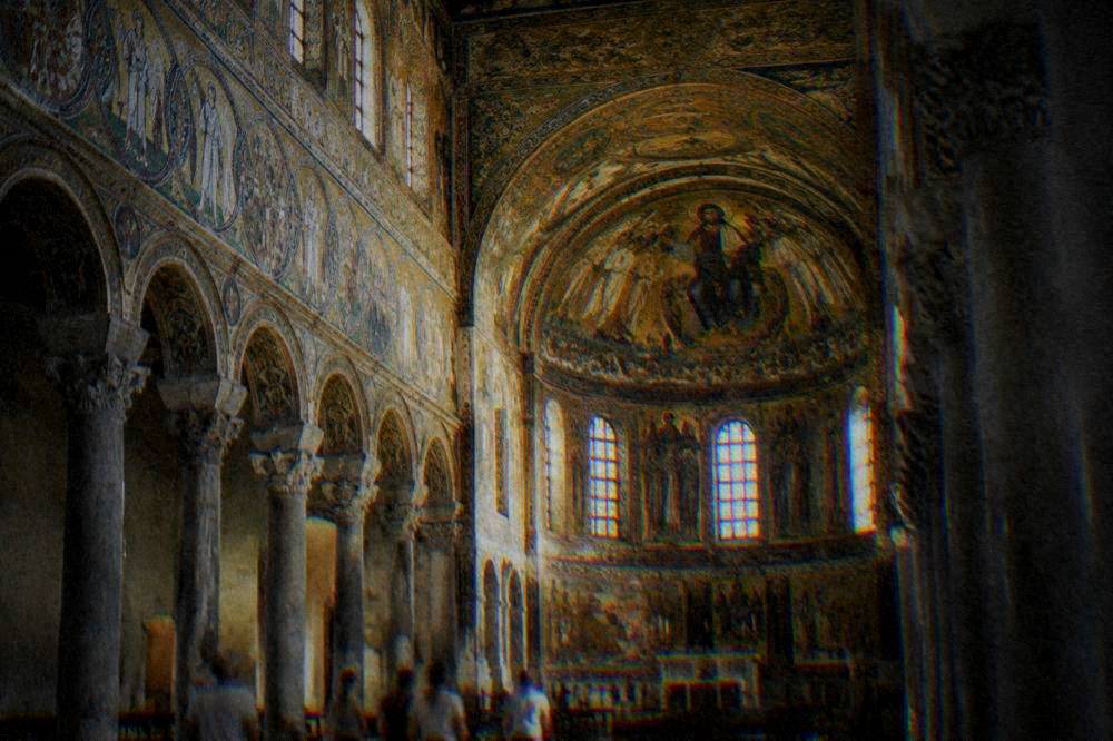 The interior of a Byzantine basilica lit by gold mosaic decoration on walls and vaults