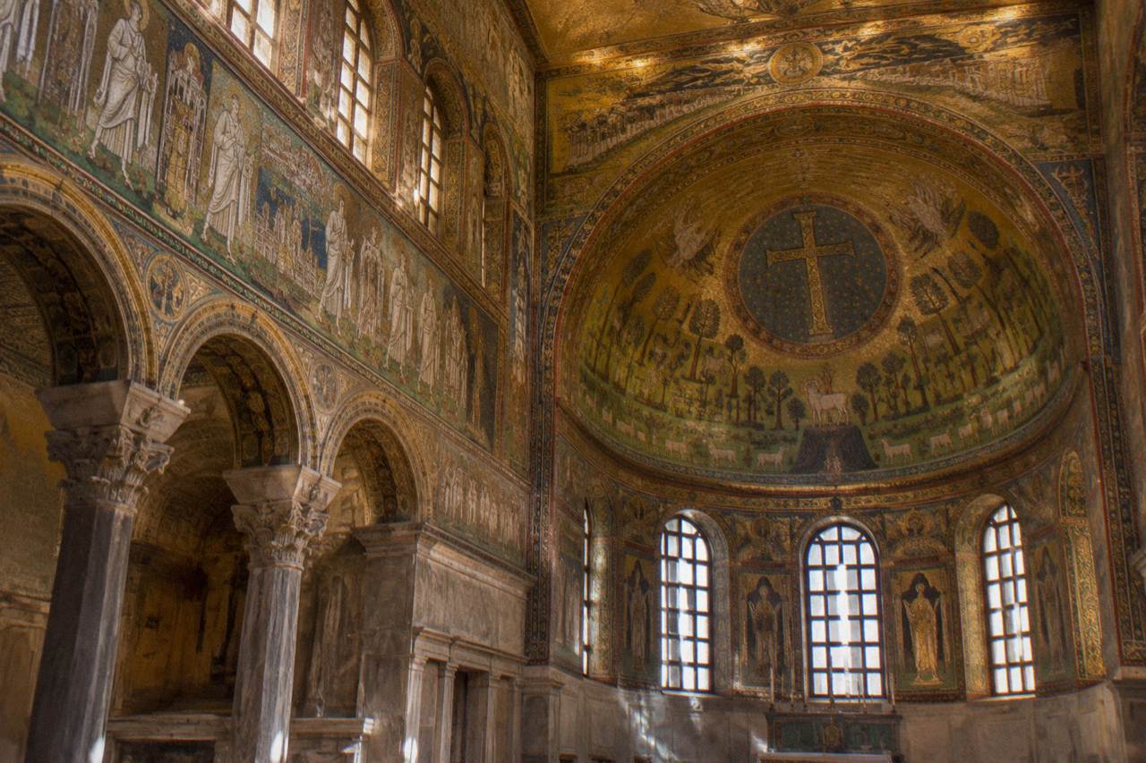 Golden mosaics glowing inside the dome of an early Christian monument in Ravenna