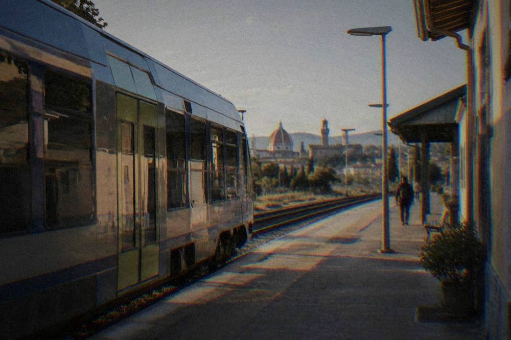 A regional train waiting at an Italian railway station platform