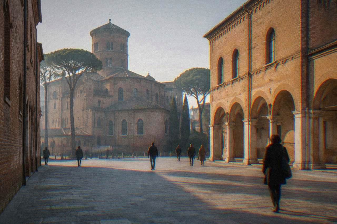 A quiet stone street in Ravenna's historic centre with bicycles parked beside old brick buildings