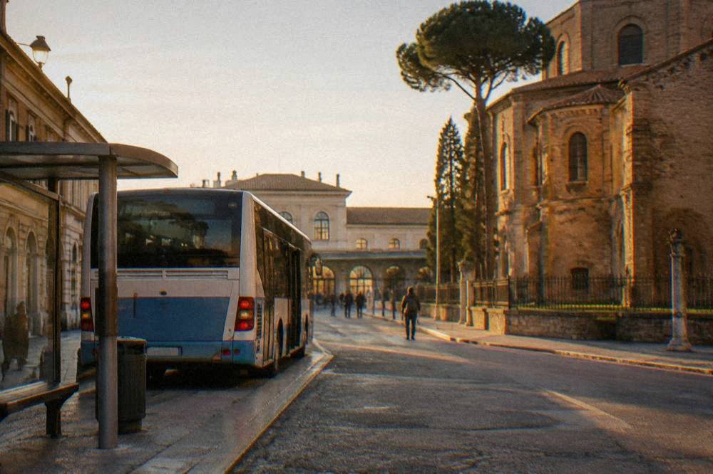 A regional bus parked at a stop near Ravenna railway station