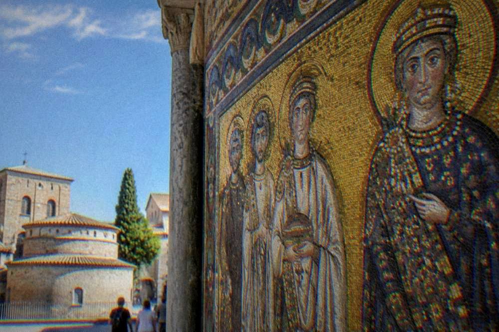 Detail of a Byzantine mosaic wall with gold tesserae and figures