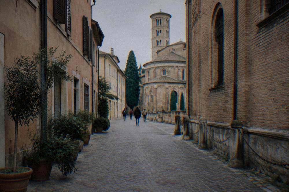A narrow cobbled street in an old Italian town centre closed to traffic