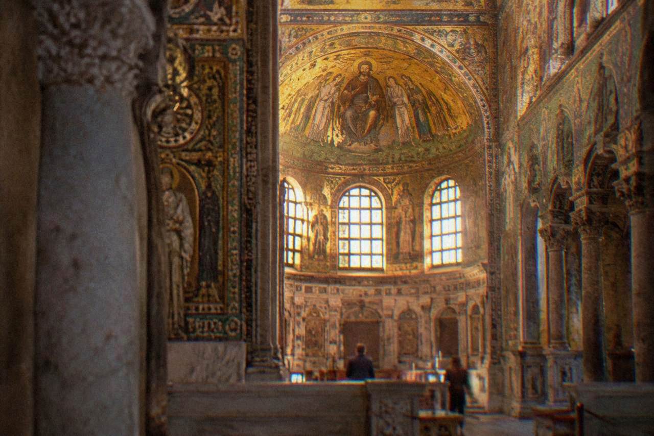 A golden Byzantine mosaic interior glowing inside an ancient Ravenna church