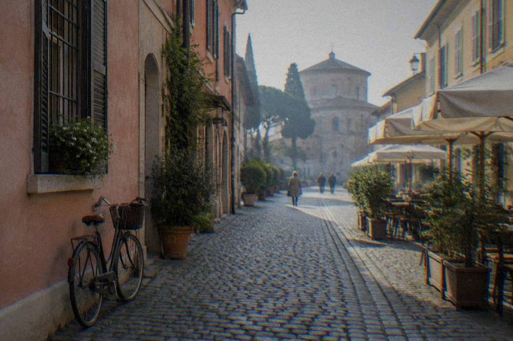 An apartment balcony overlooking tiled rooftops in Ravenna's historic centre