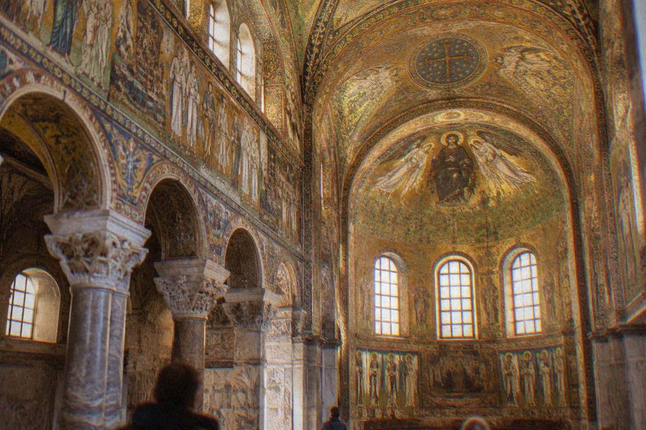 Golden Byzantine mosaics covering the vaulted interior of an early Christian monument in Ravenna