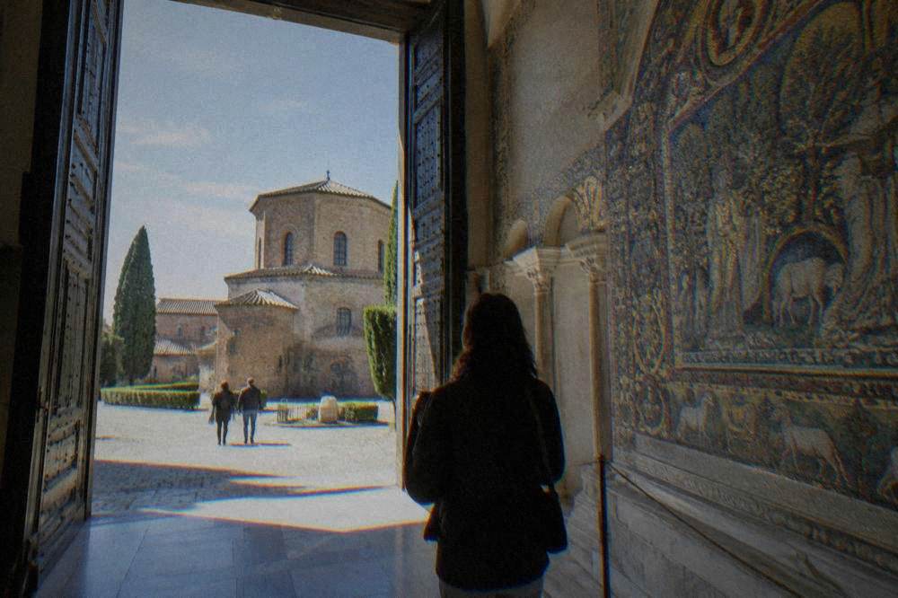 A ticket desk and queue at a mosaic monument entrance in Ravenna