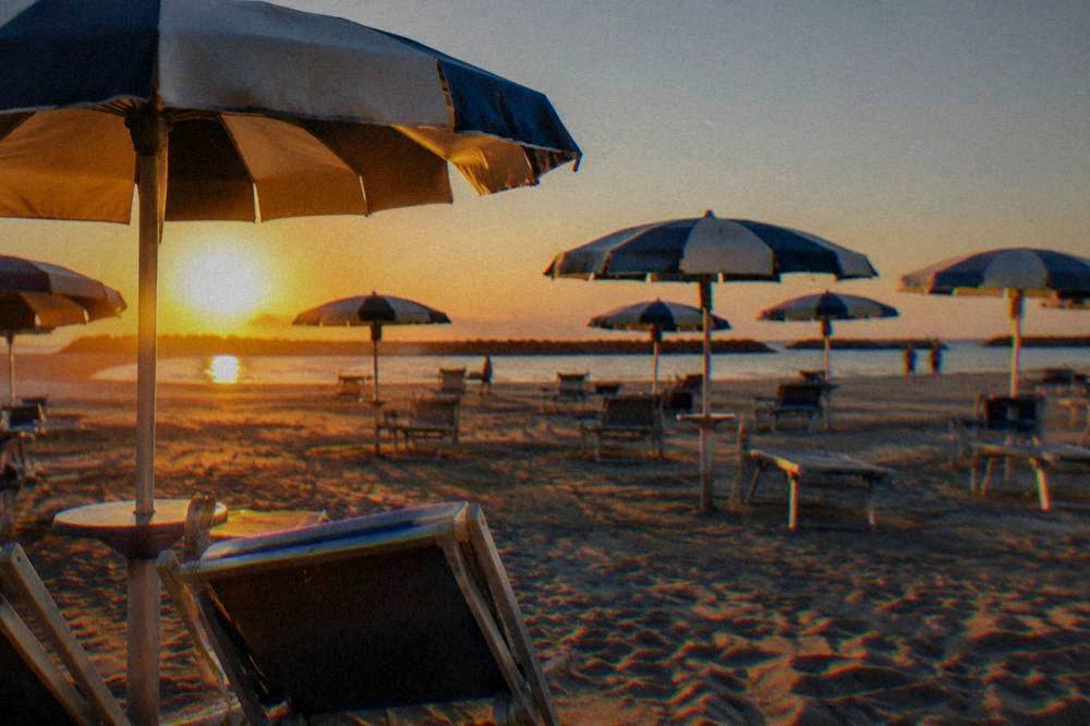 Umbrellas and sand at an Adriatic beach resort near Ravenna under a clear sky