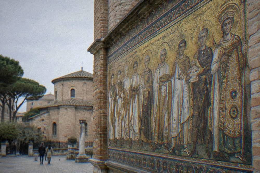 Processional figures in gold mosaic on a basilica wall in Ravenna
