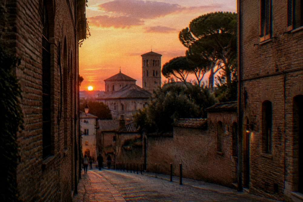 Evening light on a narrow street of brick buildings in Ravenna
